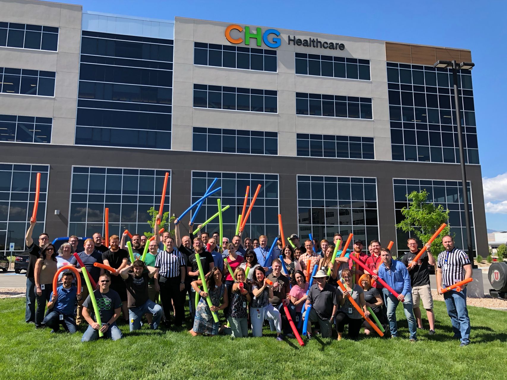 Group of CHG employees in front of HQ