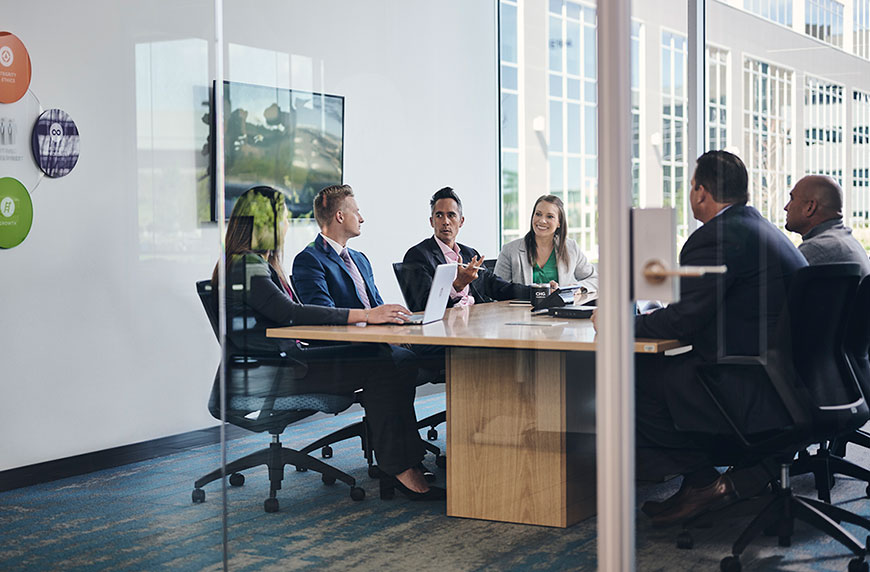 Healthcare administrators in conference room discussing state of locum tenens