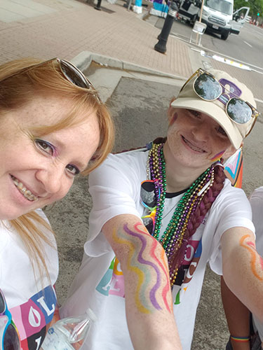 CHG employee and their child at the Salt Lake City Pride parade