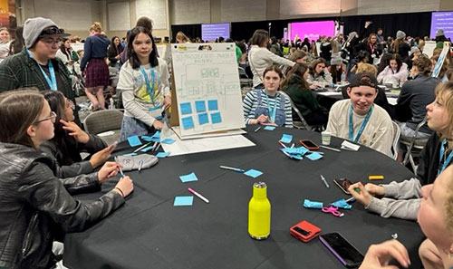 group of WIT and Wisdom members whiteboarding at shetech